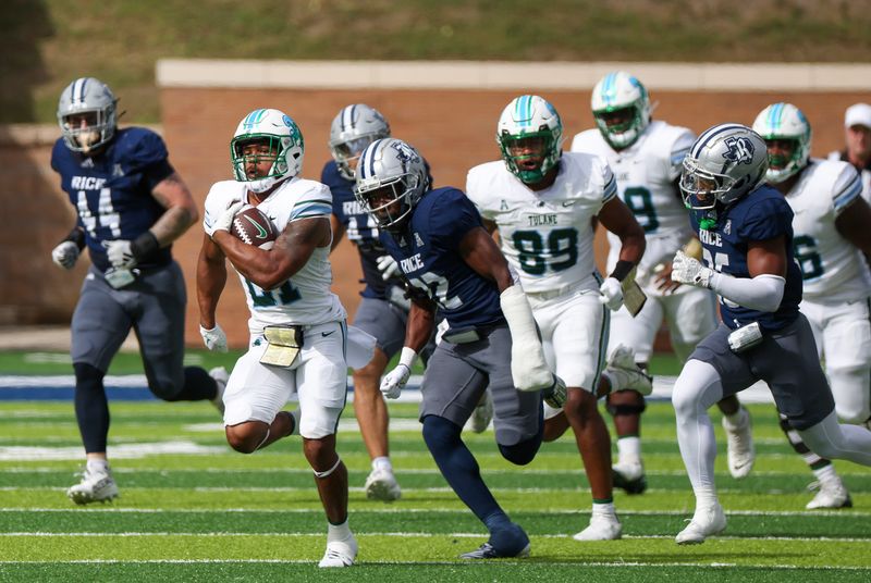 Oct 28, 2023; Houston, Texas, USA; Tulane Green Wave running back Makhi Hughes (21) rushes against Rice Owls cornerback Jonathan Jean (22) for a first down in the first half at Rice Stadium. Mandatory Credit: Thomas Shea-USA TODAY Sports