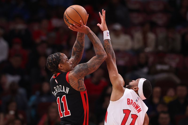 CHICAGO, ILLINOIS - JANUARY 30: DeMar DeRozan #11 of the Chicago Bulls shoots over Bruce Brown #11 of the Toronto Raptors during the second half at the United Center on January 30, 2024 in Chicago, Illinois. NOTE TO USER: User expressly acknowledges and agrees that, by downloading and or using this photograph, User is consenting to the terms and conditions of the Getty Images License Agreement.  (Photo by Michael Reaves/Getty Images)