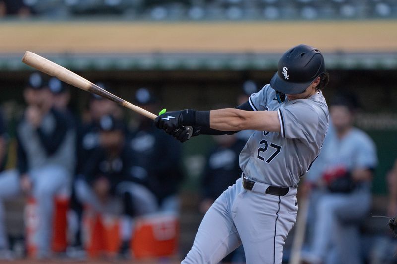 Aug 6, 2024; Oakland, California, USA;  Chicago White Sox shortstop Brooks Baldwin (27) hits a single during the first inning against the Chicago White Sox at Oakland-Alameda County Coliseum. Mandatory Credit: Stan Szeto-USA TODAY Sports