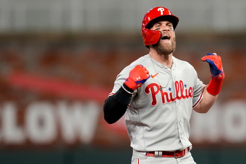 Oct 12, 2022; Atlanta, Georgia, USA; Philadelphia Phillies designated hitter Bryce Harper (3) reacts to hitting a double against the Atlanta Braves in the second inning during game two of the NLDS for the 2022 MLB Playoffs at Truist Park. Mandatory Credit: Dale Zanine-USA TODAY Sports