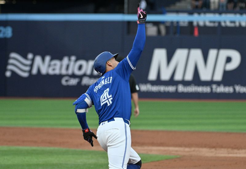 Jul 2, 2024; Toronto, Ontario, CAN;  Toronto Blue Jays right fielder George Springer (4) reacts after hitting a three run home run against the Houston Astros in the third inning at Rogers Centre. Mandatory Credit: Dan Hamilton-USA TODAY Sports