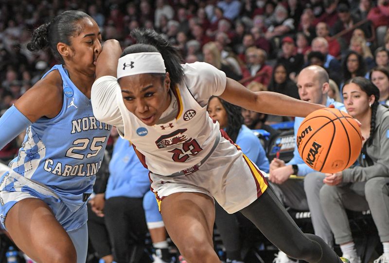 Mar 24, 2034; Columbia, So Carolina, USA;  South Carolina guard Bree Hall (23) dribbles by University of North Carolina guard Deja Kelly (25), with her elbow bumping Kelly's nose, during the second quarter of the second round NCAA Women's Basketball Tournament game at the Colonial Life Center.  Mandatory Credit: Ken Ruinard-USA TODAY Sports via Greenville News