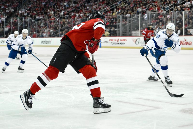 Feb 25, 2024; Newark, New Jersey, USA; New Jersey Devils right wing Timo Meier (28) shoots the puck as Tampa Bay Lightning defenseman Emil Martinsen Lilleberg (78) defends during the second period at Prudential Center. Mandatory Credit: John Jones-USA TODAY Sports