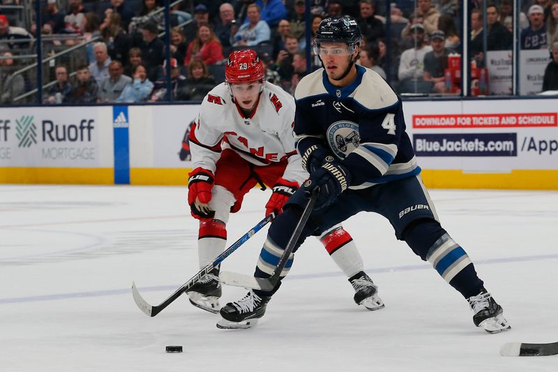 Apr 16, 2024; Columbus, Ohio, USA; Columbus Blue Jackets forward Cole Sillinger (4) controls the puck as Carolina Hurricanes left wing Brady Nadeau (29) trails the play during the second period at Nationwide Arena. Mandatory Credit: Russell LaBounty-USA TODAY Sports