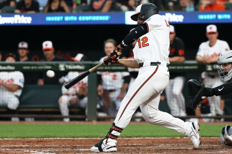 Jun 10, 2025; Baltimore, Maryland, USA; Baltimore Orioles outfielder Ramon Laureano (12) hits a single during the sixth inning against the Detroit Tigers at Oriole Park at Camden Yards. Mandatory Credit: Daniel Kucin Jr.-Imagn Images