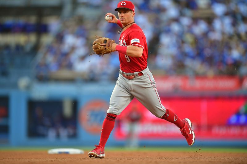 Jul 29, 2023; Los Angeles, California, USA; Cincinnati Reds second baseman Matt McLain (9) throws to first for the out against Los Angeles Dodgers center fielder James Outman (33) during the fourth inning at Dodger Stadium. Mandatory Credit: Gary A. Vasquez-USA TODAY Sports