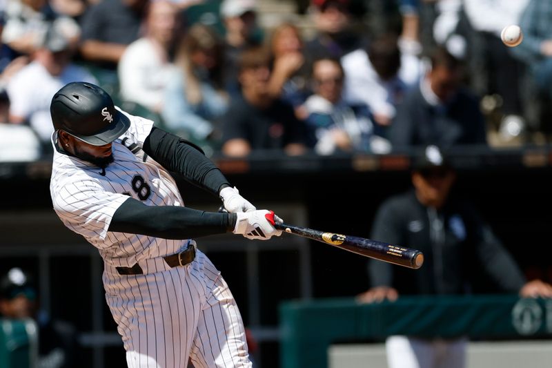 May 25, 2025; Chicago, Illinois, USA; Chicago White Sox center fielder Luis Robert Jr. (88) hits an RBI-sacrifice fly against the Texas Rangers during the sixth inning at Rate Field. Mandatory Credit: Kamil Krzaczynski-Imagn Images