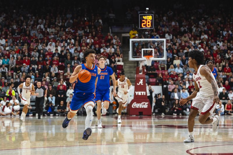 Mar 5, 2025; Tuscaloosa, Alabama, USA; Florida Gators guard Walter Clayton Jr. (1) drives the ball against Alabama Crimson Tide guard Aden Holloway (2) during the first half at Coleman Coliseum. Mandatory Credit: Will McLelland-Imagn Images