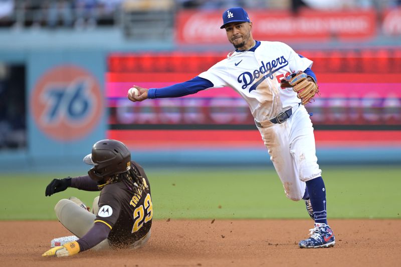 Apr 14, 2024; Los Angeles, California, USA; San Diego Padres outfielder Fernando Tatis Jr. (23) is out at second as Los Angeles Dodgers shortstop Mookie Betts (50) throws to first to complete a double play in the fifth inning at Dodger Stadium. Mandatory Credit: Jayne Kamin-Oncea-USA TODAY Sports
