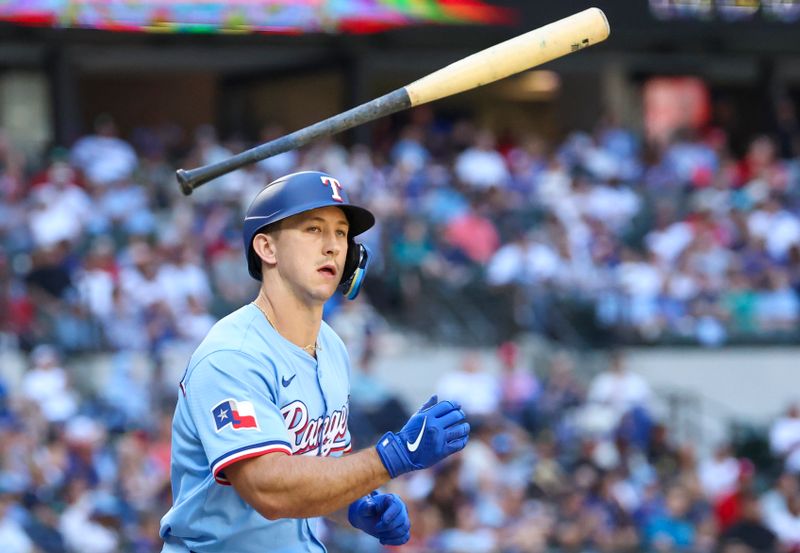 May 4, 2025; Arlington, Texas, USA;  Texas Rangers left fielder Wyatt Langford (36) flips his bat after getting a walk during the sixth inning against the Seattle Mariners at Globe Life Field. Mandatory Credit: Kevin Jairaj-Imagn Images