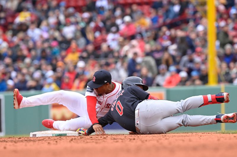 Apr 18, 2024; Boston, Massachusetts, USA;  Boston Red Sox second baseman Enmanuel Valdez (47)  tags Cleveland Guardians second baseman Andres Gimenez (0) out during the third inning at Fenway Park. Mandatory Credit: Eric Canha-USA TODAY Sports