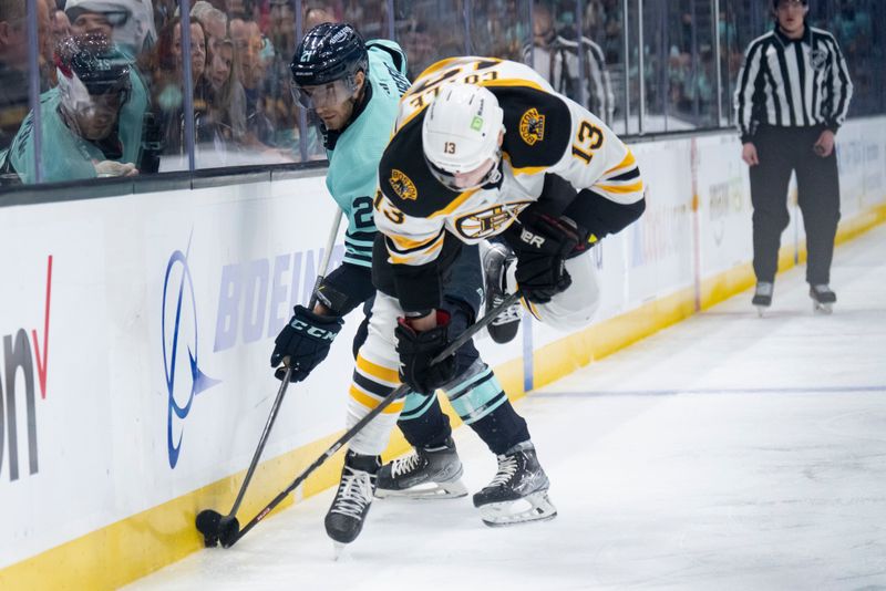 Feb 23, 2023; Seattle, Washington, USA; Seattle Kraken forward Alex Wennberg (21) and Boston Bruins forward Charlie Coyle (13) battle for the puck along the boards during the first period at Climate Pledge Arena. Mandatory Credit: Stephen Brashear-USA TODAY Sports