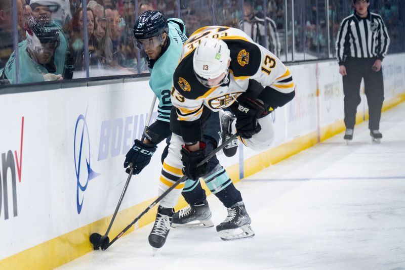 Feb 23, 2023; Seattle, Washington, USA; Seattle Kraken forward Alex Wennberg (21) and Boston Bruins forward Charlie Coyle (13) battle for the puck along the boards during the first period at Climate Pledge Arena. Mandatory Credit: Stephen Brashear-USA TODAY Sports