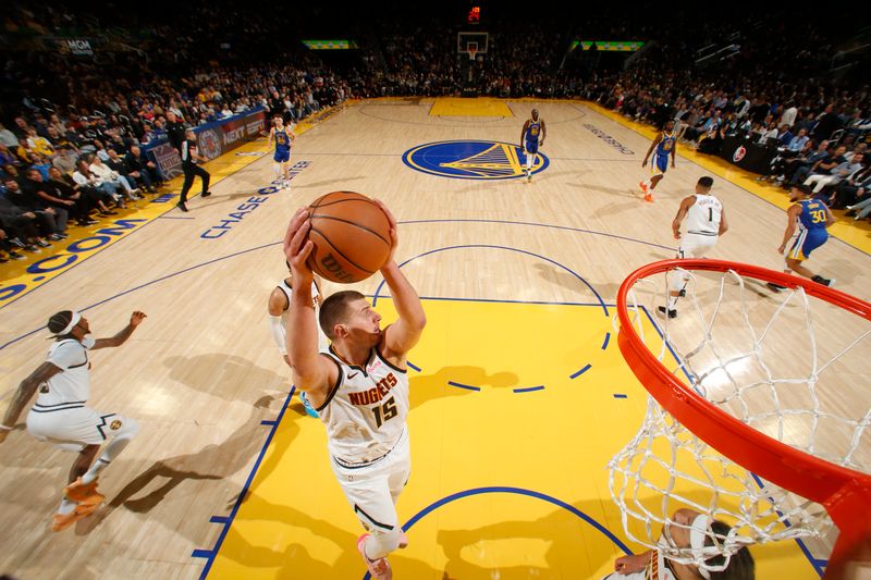 SAN FRANCISCO, CA - FEBRUARY 25: Nikola Jokic #15 of the Denver Nuggets goes up for the rebound during the game against the Golden State Warriors on February 25, 2024 at Chase Center in San Francisco, California. NOTE TO USER: User expressly acknowledges and agrees that, by downloading and or using this photograph, user is consenting to the terms and conditions of Getty Images License Agreement. Mandatory Copyright Notice: Copyright 2024 NBAE (Photo by Jed Jacobsohn/NBAE via Getty Images)