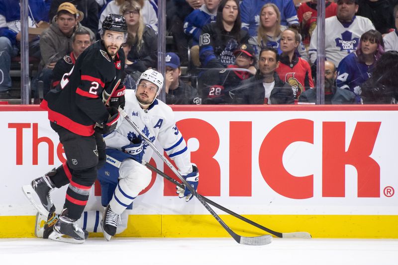 Feb 10, 2024; Ottawa, Ontario, CAN; Toronto Maple Leafs center Auston Matthews (34) is checked by Ottawa Senators defenseman Artem Zub (2) in the second period at the Canadian Tire Centre. Mandatory Credit: Marc DesRosiers-USA TODAY Sports