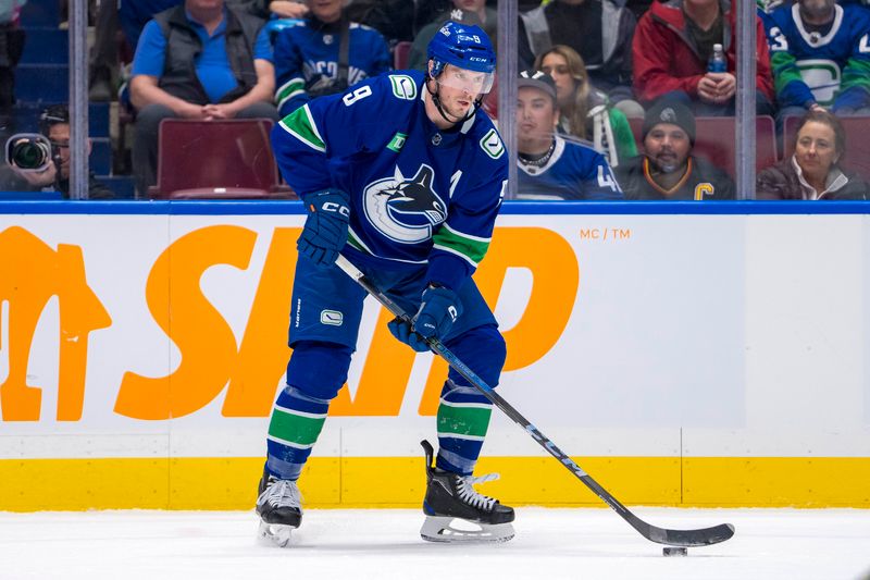 Apr 8, 2024; Vancouver, British Columbia, CAN; Vancouver Canucks forward J.T. Miller (9) handles the puck against the Vegas Golden Knights in the first period at Rogers Arena. Mandatory Credit: Bob Frid-USA TODAY Sports