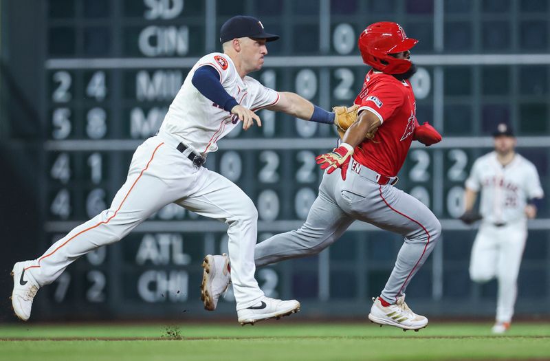 May 21, 2024; Houston, Texas, USA; Los Angeles Angels third baseman Luis Rengifo (2) is tagged out by Houston Astros third baseman Alex Bregman (2) after a rundown during the fourth inning at Minute Maid Park. Mandatory Credit: Troy Taormina-USA TODAY Sports