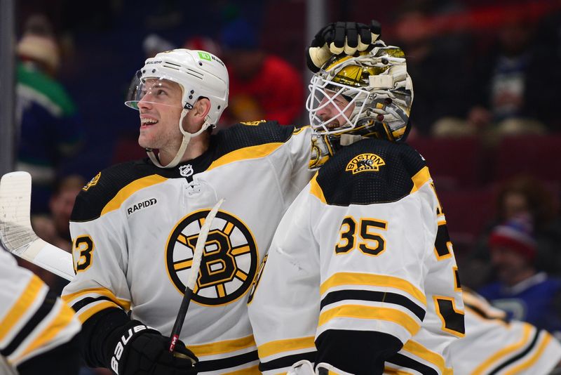 Feb 25, 2023; Vancouver, British Columbia, CAN; Boston Bruins goaltender Linus Ullmark (35) celebrates his empty net goal during the third period at Rogers Arena. Mandatory Credit: Anne-Marie Sorvin-USA TODAY Sports