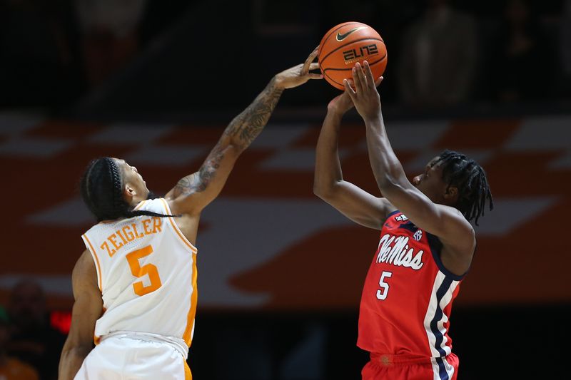 Jan 6, 2024; Knoxville, Tennessee, USA; Mississippi Rebels guard Jaylen Murray (5) shoots the ball against Tennessee Volunteers guard Zakai Zeigler (5) during the first half at Thompson-Boling Arena at Food City Center. Mandatory Credit: Randy Sartin-USA TODAY Sports