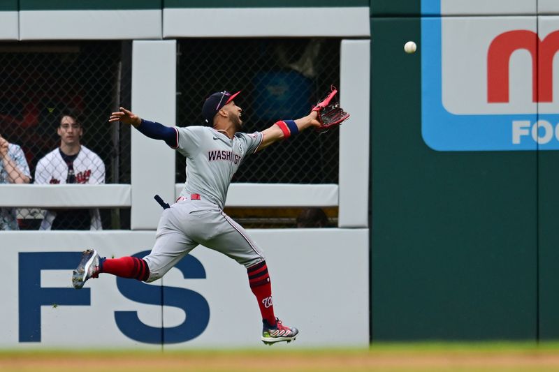 Jun 2, 2024; Cleveland, Ohio, USA; Washington Nationals right fielder Eddie Rosario (8) can not make the catch on a ball hit by Cleveland Guardians right fielder Will Brennan (not pictured) during the second inning at Progressive Field. Mandatory Credit: Ken Blaze-USA TODAY Sports