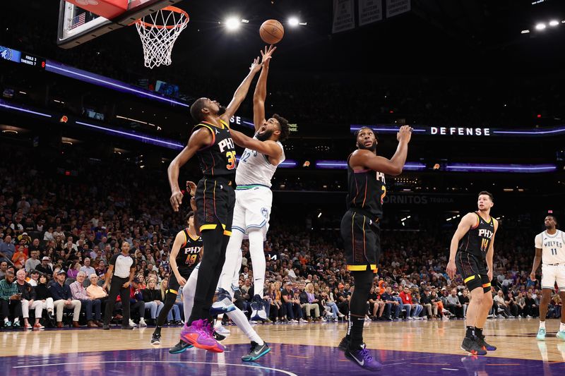 PHOENIX, ARIZONA - NOVEMBER 15: Karl-Anthony Towns #32 of the Minnesota Timberwolves attempts a shot over Kevin Durant #35 of the Phoenix Suns during the first half of the NBA game at Footprint Center on November 15, 2023 in Phoenix, Arizona. NOTE TO USER: User expressly acknowledges and agrees that, by downloading and or using this photograph, User is consenting to the terms and conditions of the Getty Images License Agreement.  (Photo by Christian Petersen/Getty Images)