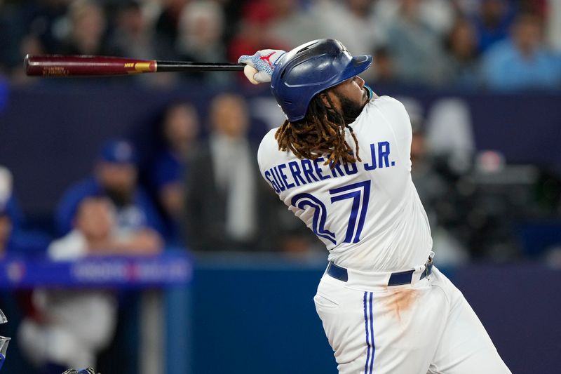 Sep 8, 2023; Toronto, Ontario, CAN; Toronto Blue Jays first baseman Vladimir Guerrero Jr. (27) hits a two RBI double against the Kansas City Royals during the seventh inning at Rogers Centre. Mandatory Credit: John E. Sokolowski-USA TODAY Sports