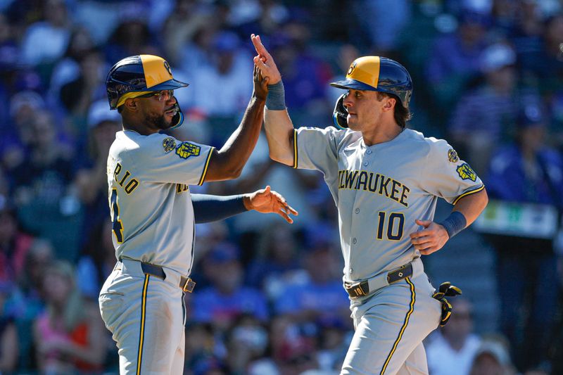 Aug 21, 2025; Chicago, Illinois, USA; Milwaukee Brewers shortstop Andruw Monasterio (14) and right fielder Sal Frelick (10) celebrate after scoring against the Chicago Cubs during the eight inning at Wrigley Field. Mandatory Credit: Kamil Krzaczynski-Imagn Images