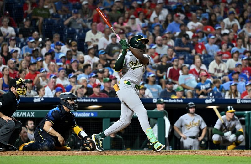 Jul 12, 2024; Philadelphia, Pennsylvania, USA; Oakland Athletics outfielder Lawrence Butler (4) hits a two-run home run against the Philadelphia Phillies in the eighth inning at Citizens Bank Park. Mandatory Credit: Kyle Ross-USA TODAY Sports