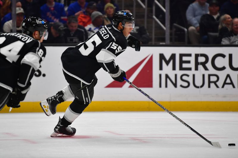 Jan 20, 2024; Los Angeles, California, USA; Los Angeles Kings right wing Quinton Byfield (55) moves the puck against the New York Rangers durng the third period at Crypto.com Arena. Mandatory Credit: Gary A. Vasquez-USA TODAY Sports