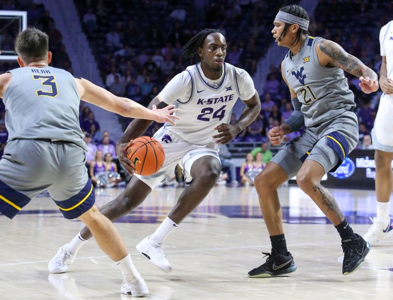 Feb 26, 2024; Manhattan, Kansas, USA; Kansas State Wildcats forward Arthur Maluma (24) dribbles between West Virginia Mountaineers guards Kerr Kriisa (3) and RaeQuan Battle (21) during the first half at Bramlage Coliseum. Mandatory Credit: Scott Sewell-USA TODAY Sports