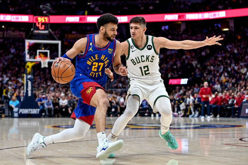 DENVER, CO - MARCH 25:  Jamal Murray #27 of the Denver Nuggets is defended by Grayson Allen #12 of the Milwaukee Bucks in the first half of a game at Ball Arena on March 25, 2023 in Denver, Colorado. NOTE TO USER: User expressly acknowledges and agrees that, by downloading and or using this photograph, User is consenting to the terms and conditions of the Getty Images License Agreement. (Photo by Dustin Bradford/Getty Images)