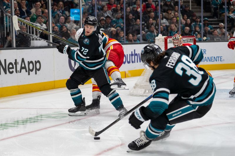 Dec 16, 2025; San Jose, California, USA; Calgary Flames defenseman Mackenzie Weegar (52) and San Jose Sharks left wing William Eklund (72) battle for position during the second period at SAP Center at San Jose. Mandatory Credit: Neville E. Guard-Imagn Images