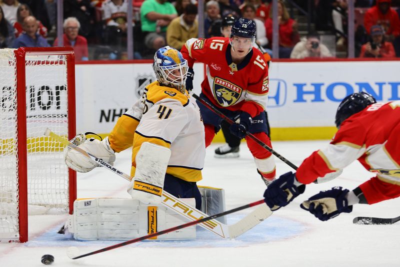 Nov 7, 2024; Sunrise, Florida, USA; Nashville Predators goaltender Scott Wedgewood (41) defends his net as Florida Panthers center Evan Rodrigues (17) dives in an attempt to shoot the puck during the second period at Amerant Bank Arena. Mandatory Credit: Sam Navarro-Imagn Images