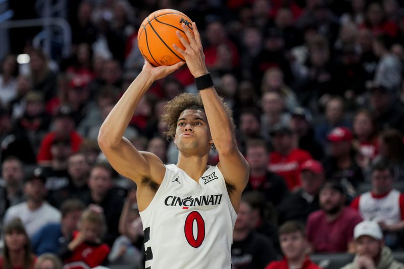 Nov 10, 2023; Cincinnati, Ohio, USA;  Cincinnati Bearcats guard Dan Skillings Jr. (0) attempts a three-point basket against the Detroit Mercy Titans in the first half at Fifth Third Arena. Mandatory Credit: Aaron Doster-USA TODAY Sports