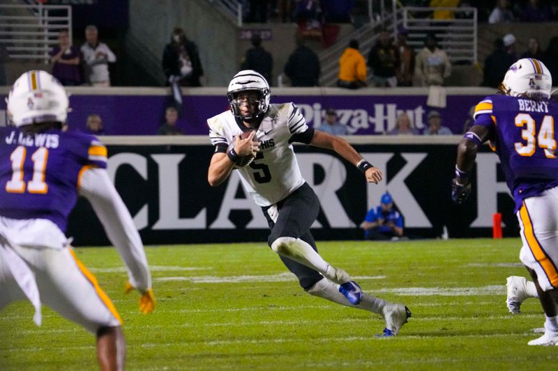 Oct 15, 2022; Greenville, North Carolina, USA;  Memphis Tigers quarterback Seth Henigan (5) runs with the ball against the East Carolina Pirates during the second half at Dowdy-Ficklen Stadium. Mandatory Credit: James Guillory-USA TODAY Sports