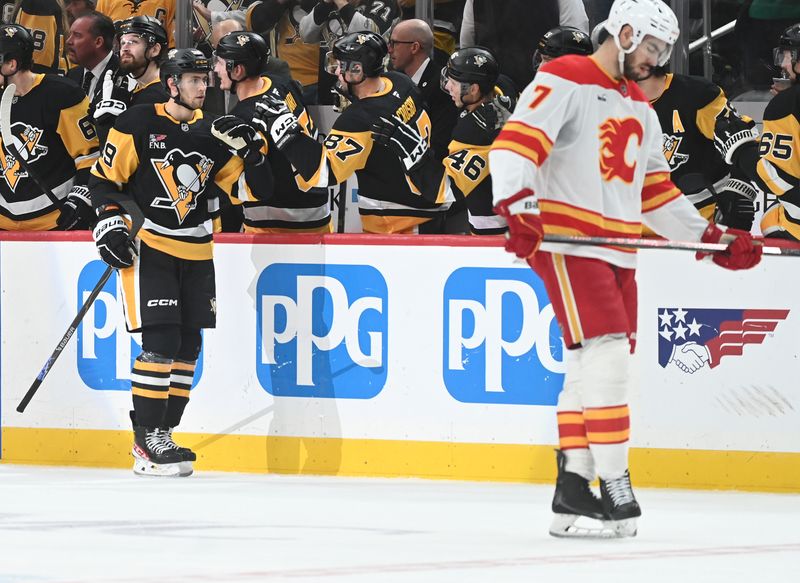 Jan 10, 2026; Pittsburgh, Pennsylvania, USA;  Pittsburgh Penguins right wing Egor Chinakov (59) is greeted by his teammates and Calgary Flames defenseman Kevin Bahl (7) skates by after a second period goal at PPG Paints Arena. Mandatory Credit: Philip G. Pavely-Imagn Images