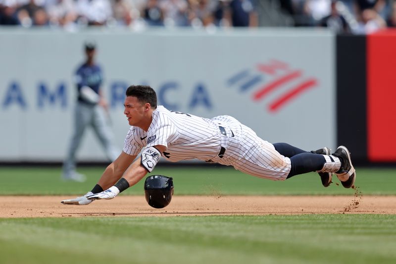 May 23, 2024; Bronx, New York, USA; New York Yankees shortstop Anthony Volpe (11) slides into second for a double against the Seattle Mariners during the seventh inning at Yankee Stadium. Mandatory Credit: Brad Penner-USA TODAY Sports