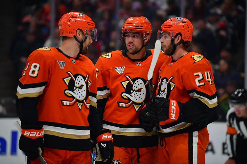 Mar 3, 2026; Anaheim, California, USA; Anaheim Ducks center Ryan Poehling (25) speaks with left wing Jeffrey Viel (28) and center Jansen Harkins (24) during the third period at Honda Center. Mandatory Credit: Gary A. Vasquez-Imagn Images
