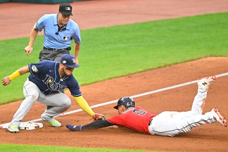 Sep 2, 2023; Cleveland, Ohio, USA; Cleveland Guardians second baseman Andres Gimenez (0) is tagged out by Tampa Bay Rays third baseman Isaac Paredes (17) in the fifth inning at Progressive Field. Mandatory Credit: David Richard-USA TODAY Sports
