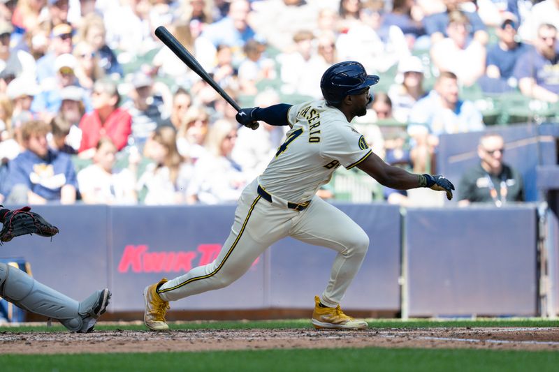 May 26, 2025; Milwaukee, Wisconsin, USA;  Milwaukee Brewers second baseman Andruw Monasterio (14) doubles during the fifth inning against the Boston Red Sox at American Family Field. Mandatory Credit: Jeff Hanisch-Imagn Images