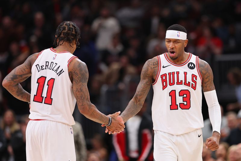 CHICAGO, ILLINOIS - OCTOBER 27: DeMar DeRozan #11 of the Chicago Bulls celebrates a basket with Torrey Craig #13 against the Toronto Raptors during the second half at the United Center on October 27, 2023 in Chicago, Illinois. NOTE TO USER: User expressly acknowledges and agrees that, by downloading and or using this photograph, User is consenting to the terms and conditions of the Getty Images License Agreement. (Photo by Michael Reaves/Getty Images)