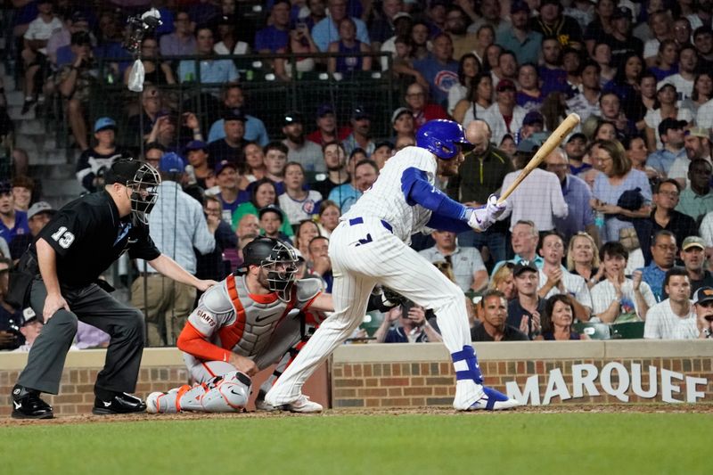 Jun 18, 2024; Chicago, Illinois, USA; Chicago Cubs outfielder Cody Bellinger (24) hits a one run single against the San Francisco Giants during the eighth inning at Wrigley Field. Mandatory Credit: David Banks-USA TODAY Sports