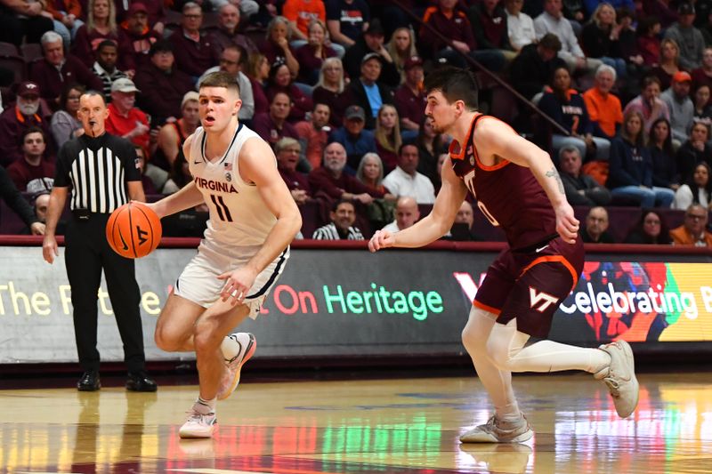 Feb 19, 2024; Blacksburg, Virginia, USA; Virginia Cavaliers guard Isaac McKneely (11) moves the ball against Virginia Tech Hokies guard Hunter Cattoor (0) during the first half at Cassell Coliseum. Mandatory Credit: Brian Bishop-USA TODAY Sports