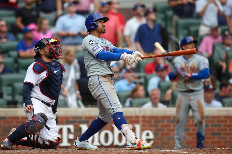 Sep 30, 2024; Atlanta, Georgia, USA; New York Mets shortstop Francisco Lindor (12) hits a two-run home run against the Atlanta Braves in the ninth inning at Truist Park. Mandatory Credit: Brett Davis-Imagn Images