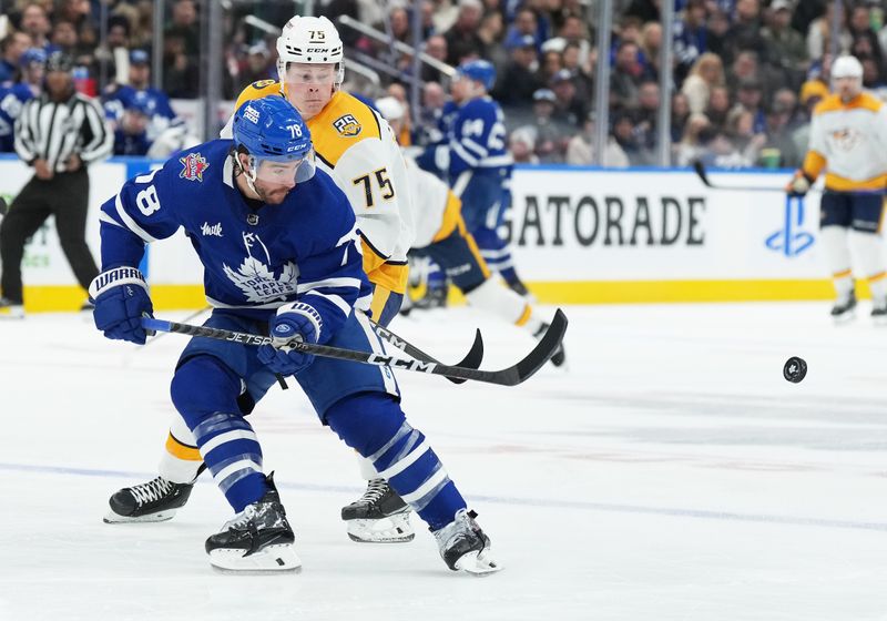 Dec 9, 2023; Toronto, Ontario, CAN; Nashville Predators center Juuso Parssinen (75) battles for the puck with Toronto Maple Leafs defenseman TJ Brodie (78) during the second period at Scotiabank Arena. Mandatory Credit: Nick Turchiaro-USA TODAY Sports