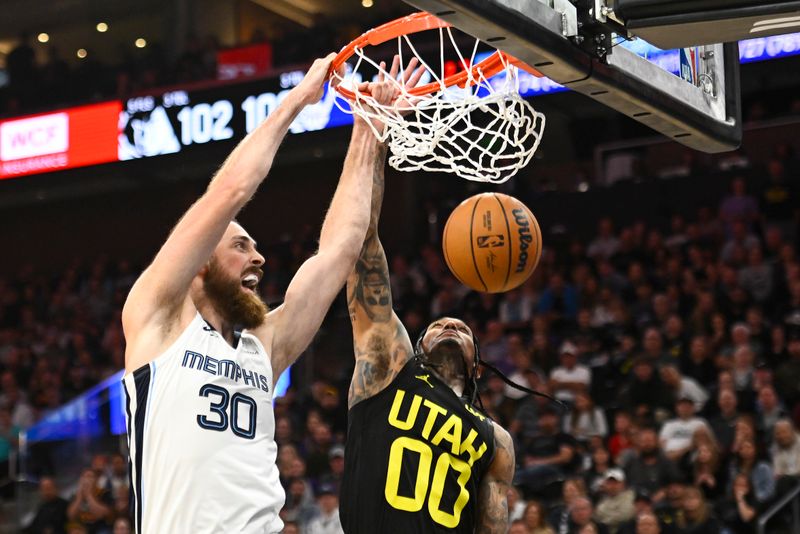 SALT LAKE CITY, UTAH - OCTOBER 23: Jay Huff #30 of the Memphis Grizzlies dunks the ball over Jordan Clarkson #00 of the Utah Jazz during the fourth quarter at Delta Center on October 23, 2024 in Salt Lake City, Utah. NOTE TO USER: User expressly acknowledges and agrees that, by downloading and or using this photograph, User is consenting to the terms and conditions of the Getty Images License Agreement. (Photo by Alex Goodlett/Getty Images)