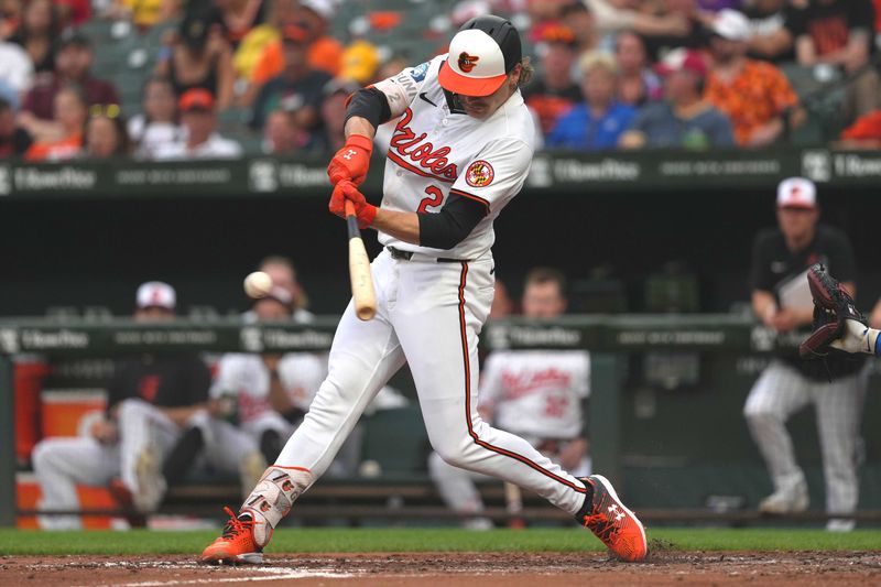 Jul 9, 2024; Baltimore, Maryland, USA; Baltimore Orioles shortstop Gunnar Henderson (2) connects for a single in the third inning against the Chicago Cubs at Oriole Park at Camden Yards. Mandatory Credit: Mitch Stringer-USA TODAY Sports