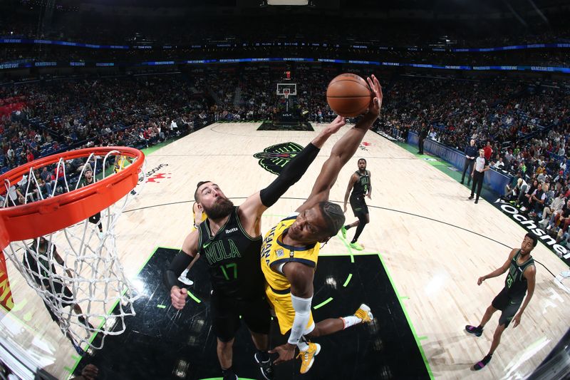 NEW ORLEANS, LA - MARCH 1:  Jonas Valanciunas #17 of the New Orleans Pelicans blocks the shot of Bennedict Mathurin #00 of the Indiana Pacers on March 1, 2024 at the Smoothie King Center in New Orleans, Louisiana. NOTE TO USER: User expressly acknowledges and agrees that, by downloading and or using this Photograph, user is consenting to the terms and conditions of the Getty Images License Agreement. Mandatory Copyright Notice: Copyright 2024 NBAE (Photo by Layne Murdoch Jr./NBAE via Getty Images)