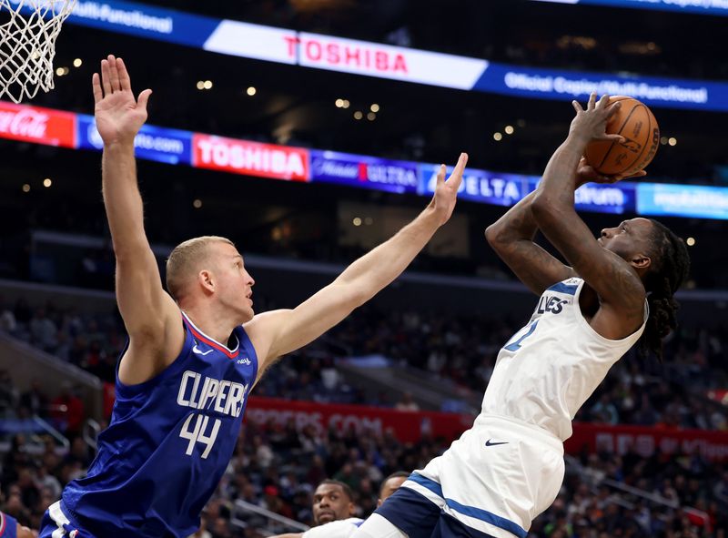 LOS ANGELES, CALIFORNIA - FEBRUARY 28: Naz Reid #11 of the Minnesota Timberwolves attempts a shot in front of Mason Plumlee #44 of the LA Clippers during a 108-101 Timberwolves win at Crypto.com Arena on February 28, 2023 in Los Angeles, California. NOTE TO USER: User expressly acknowledges and agrees that, by downloading and or using this photograph, user is consenting to the terms and conditions of the Getty Images License Agreement. (Photo by Harry How/Getty Images)