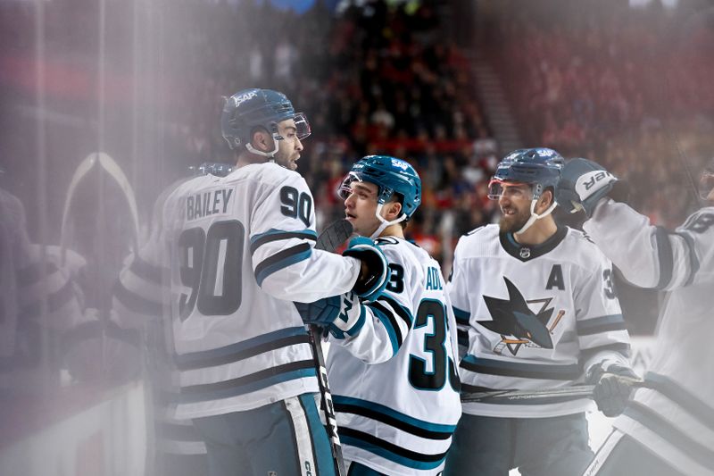 Feb 15, 2024; Calgary, Alberta, CAN; San Jose Sharks right wing Justin Bailey (90) celebrates with teammates after scoring a goal against the Calgary Flames during the second period at Scotiabank Saddledome. Mandatory Credit: Brett Holmes-USA TODAY Sports